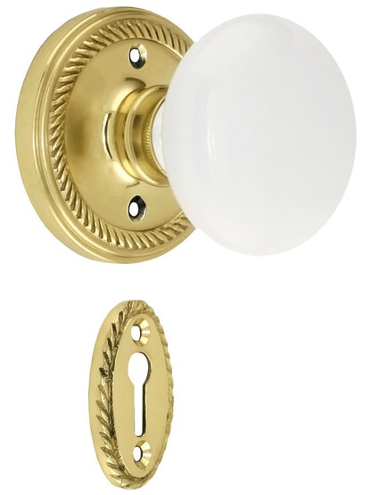 Rope Rosette Mortise Lock Set With White Porcelain Door Knobs in Polished Brass.